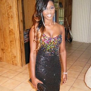 Black sequins dress with high leg slit.